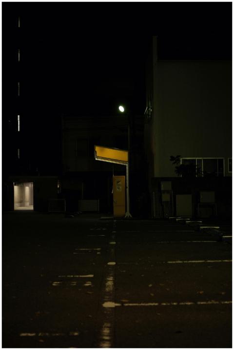 Atmospheric urban street at night with glowing lig