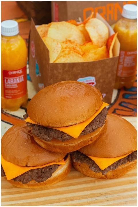 Tasty cheeseburgers with a side of chips and fresh