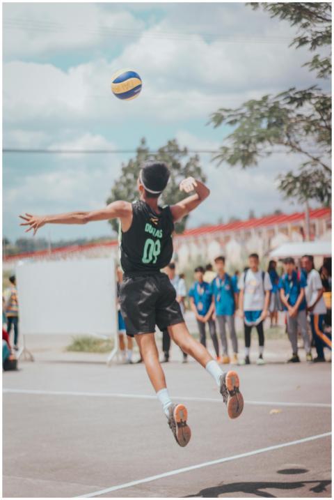 Energetic volleyball game outdoors with young athl