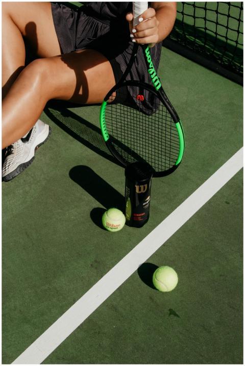 Casual scene of a woman resting on a tennis court