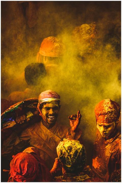 Joyful group celebrating Holi with vibrant colors