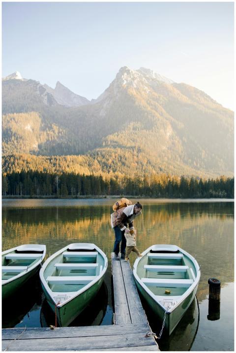 Father with little kid in warm clothes standing on