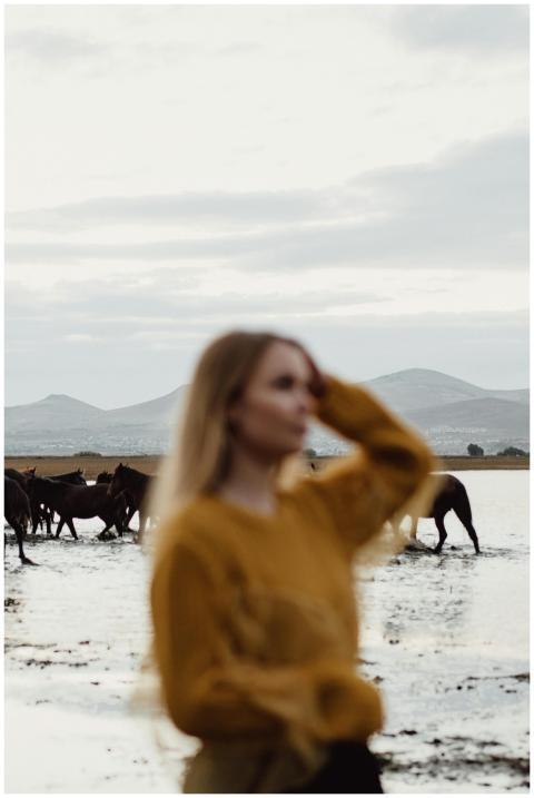 Blurred portrait of a woman outdoors with wild hor