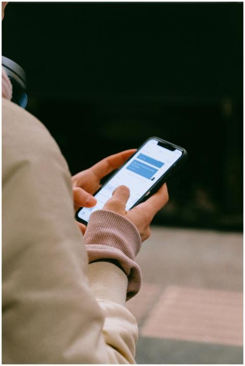 A person using a smartphone for texting, focusing