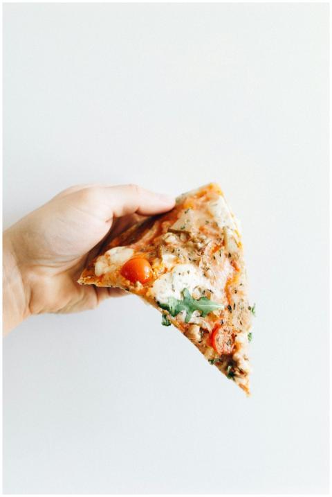 Delicious pizza slice with fresh ingredients in a