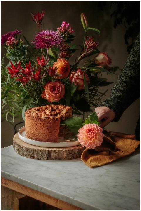 A delicious rustic cake on wooden slab with a vibr