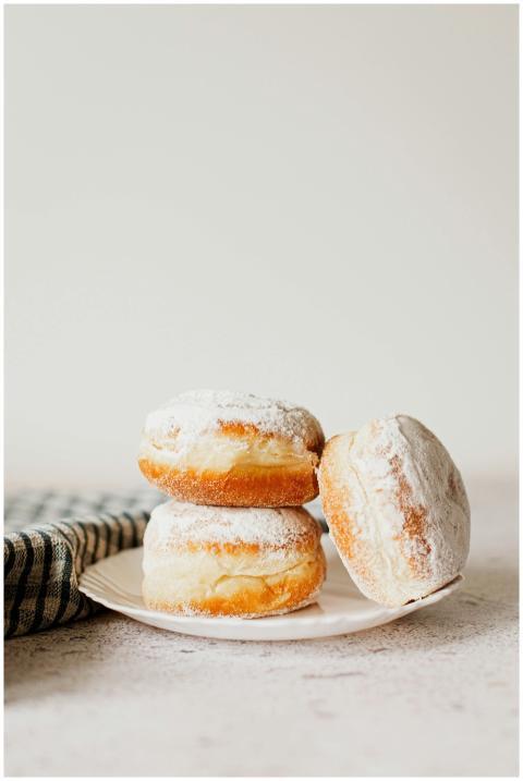 A delicious stack of fluffy powdered sugar donuts