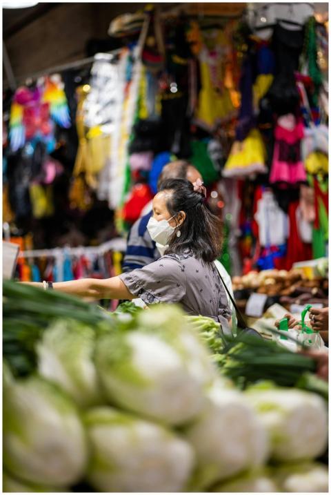 Brunette woman wearing a face mask shopping at a c