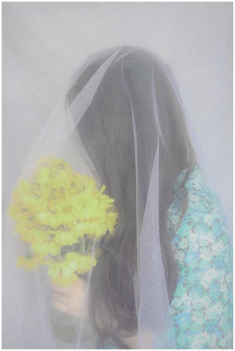 Artistic portrait of a bride with a bouquet under