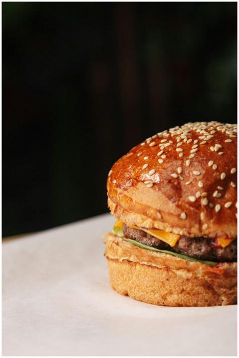 Close-up of a mouth-watering cheeseburger on parch