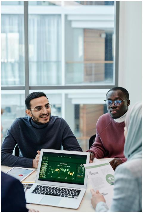 Multiethnic team discussing business analytics dat