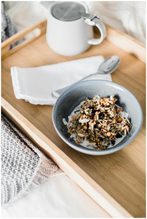 From above of bowl with muesli with milk and small