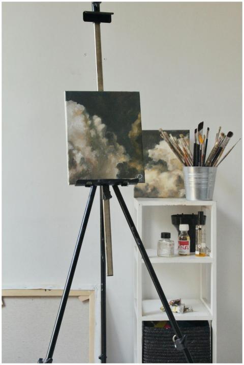 A creative indoor studio featuring cloud paintings