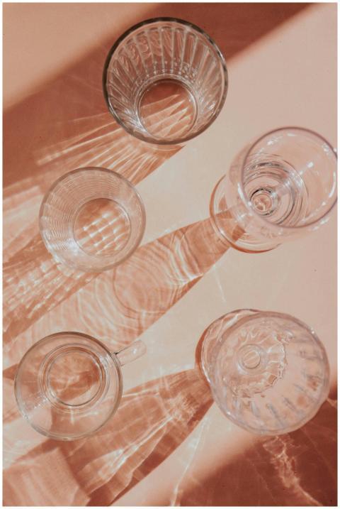 Top view of artistic glass cup shadows on a beige