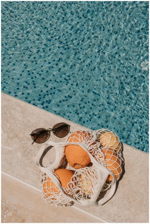 A relaxing summer setup with oranges and sunglasse