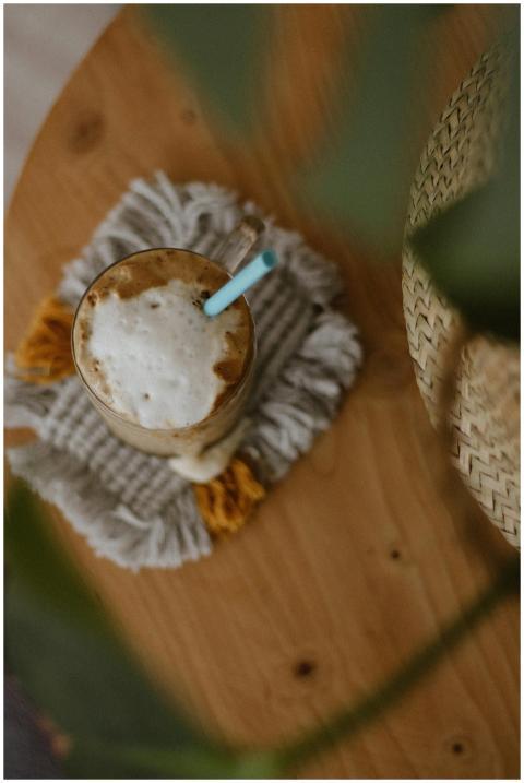 Top view of tasty coffee in glass cup with blue st