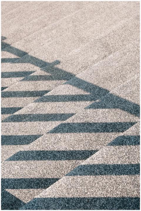 Geometric shadow patterns on urban steps creating