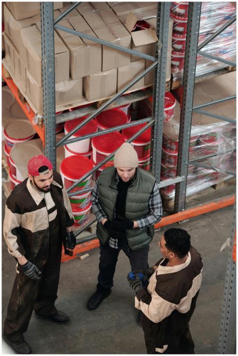 Group of warehouse workers discussing logistics in