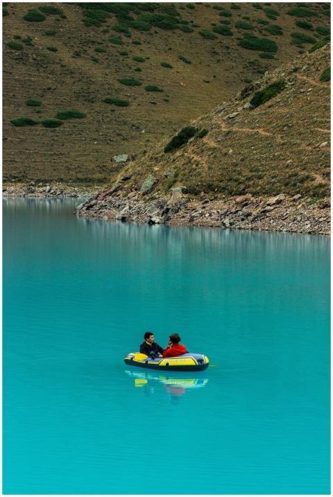 Two people in an inflatable boat on a striking tur