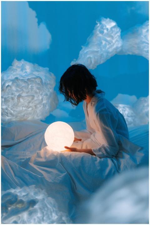 A serene scene of a woman holding an illuminated m