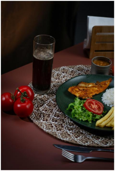 A delicious grilled chicken meal with fresh tomato