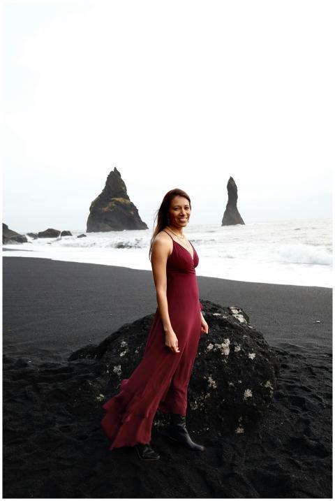 Woman in elegant red dress on Reynisfjara Beach, I