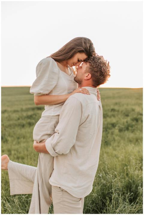 A loving couple shares a romantic embrace in a sun