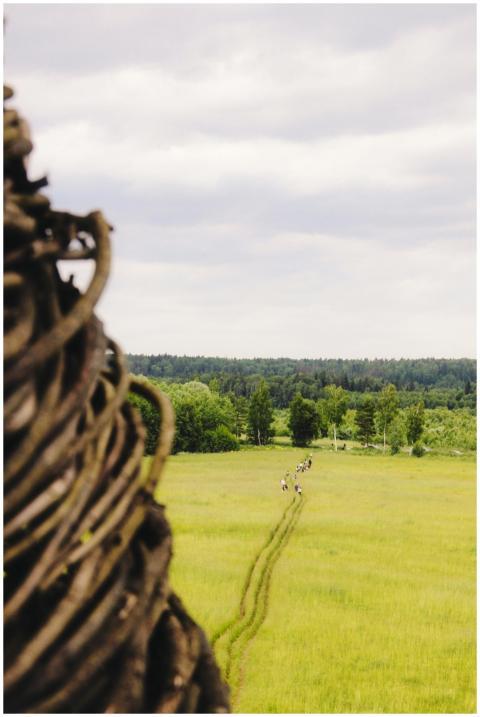 People walk along a path cutting through lush farm