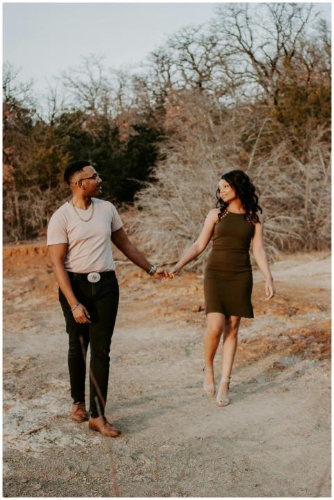 Romantic couple walking hand in hand in a natural