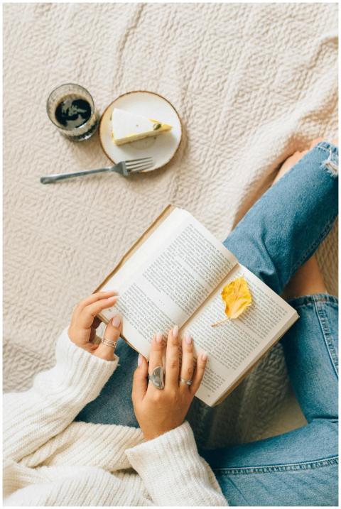 Woman enjoying leisure time at home with a book, c