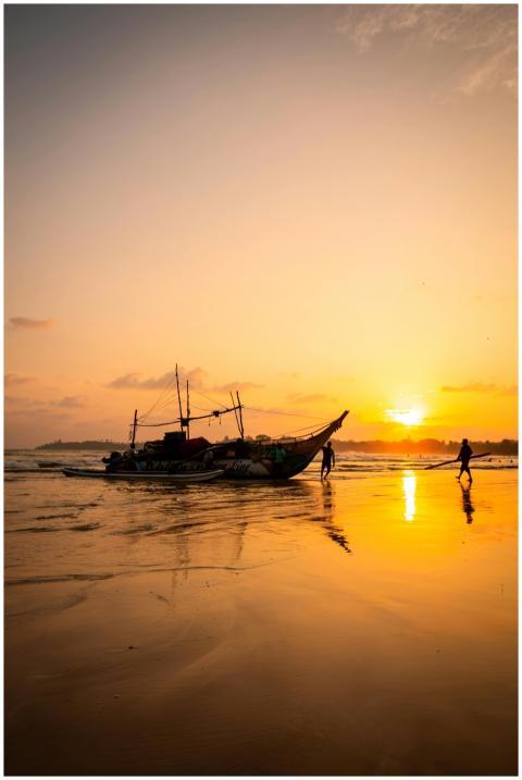 Beautiful sunset view with a fishing boat on the b