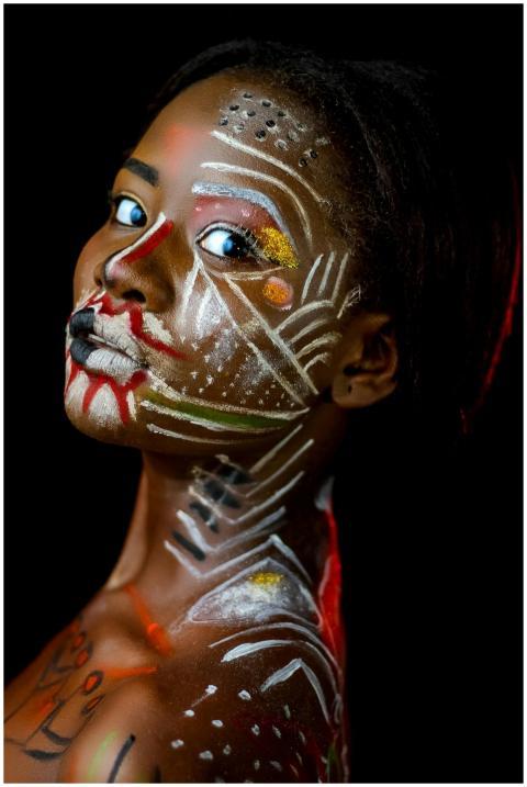 Close-up portrait of a woman with vivid body paint