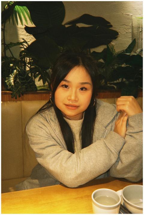 Young woman in a cozy café setting with a warm atm