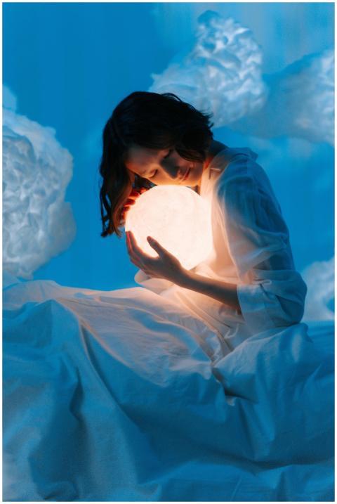 A woman in a surreal setting embraces a glowing sp