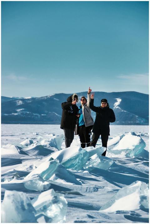 Three people enjoying and celebrating on a snowy a