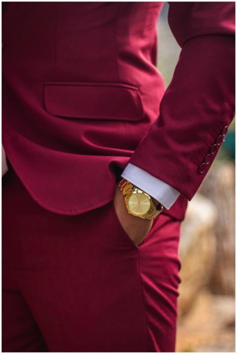 Close-up of a man in a burgundy suit showcasing a