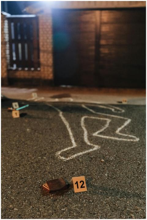 Chalk outline and evidence markers at a crime scen
