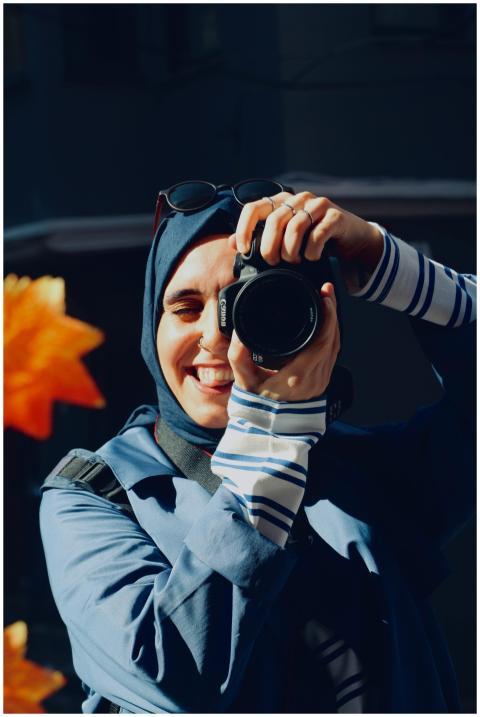 Female photographer enjoying a sunny outdoor photo