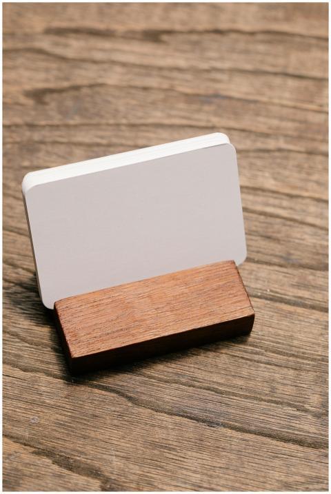 Close-up of a blank business card in a wooden hold