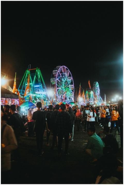 Crowded evening scene of an illuminated carnival w