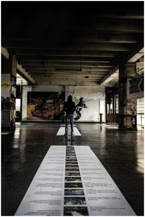 A visitor explores an urban art exhibition in a sp