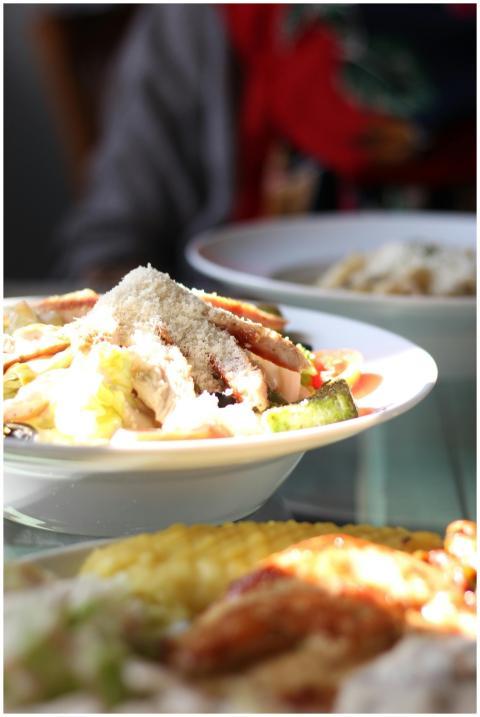 Delicious Caesar salad topped with fresh vegetable