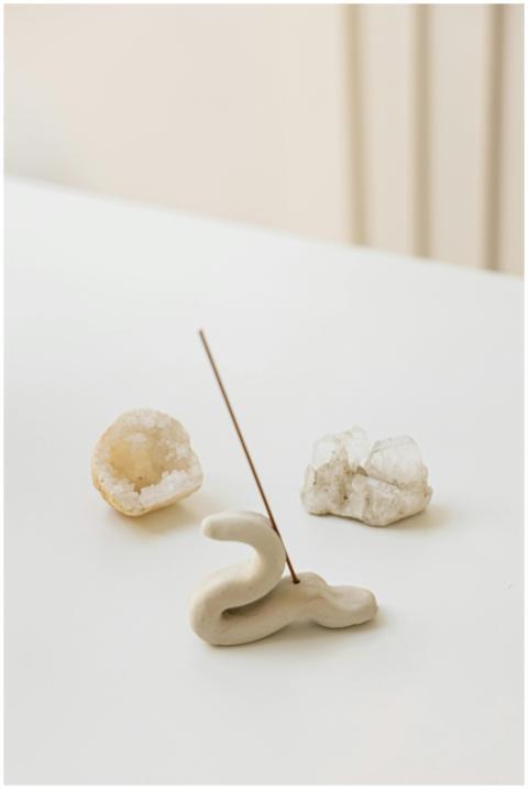 Elegant ceramic incense holder with crystals on a