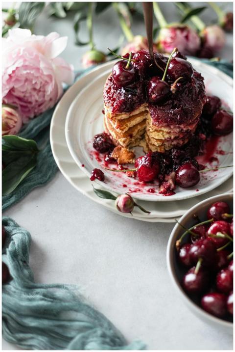Delicious cherry-topped pancakes styled with peoni