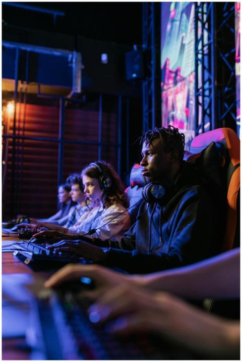 A diverse group of focused gamers competing in an