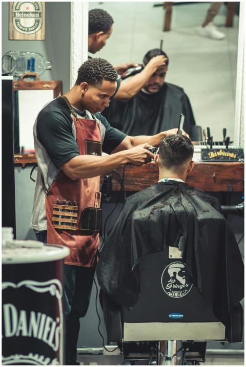 Barber skillfully cutting hair in a trendy barbers