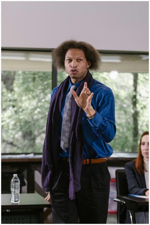 A professional presenter speaking energetically at