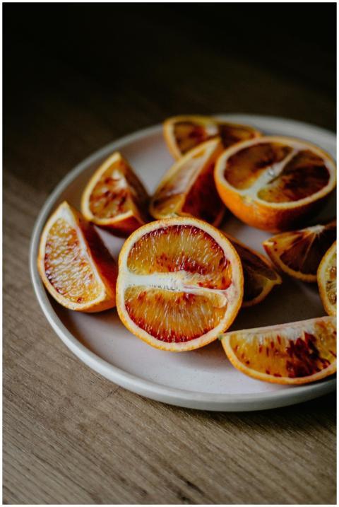 High angle of red oranges cut on halves and slices