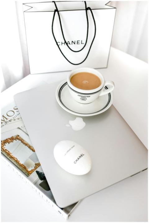 A stylish workspace featuring a laptop, coffee cup