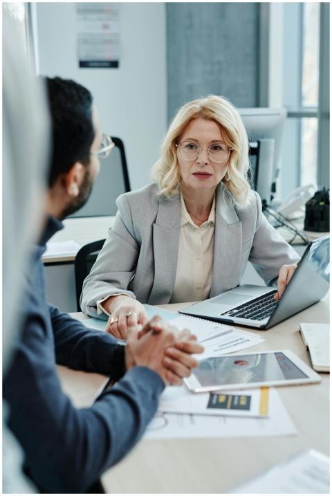Caucasian woman leading a business meeting in a mo